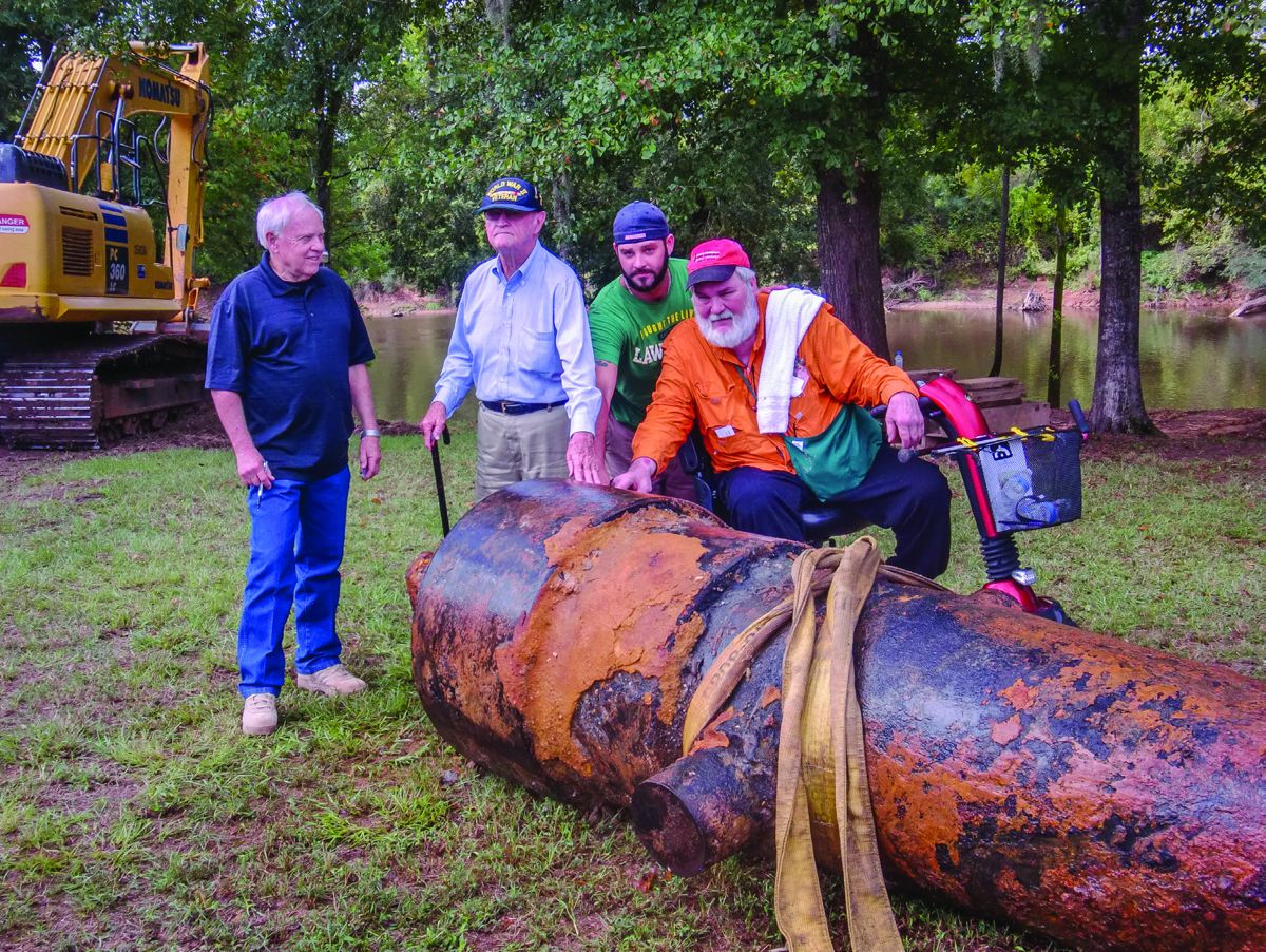 Ted Gragg, Catesby ap C. Jones, Parker and William Lockridge touch the massive 7-inch double-banded Brooke rifle for a parting photograph.