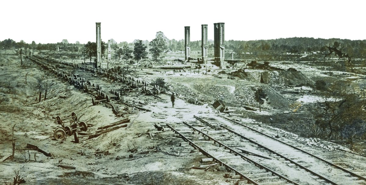 About the only burning done by Hood’s troops was here, at the eastern edge of Atlanta. As they evacuated on the night of September 1-2, Confederates torched the iron rolling mill along the Georgia Railroad. Near it they also set fire to more than two dozen railroad cars filled with ammunition, which could not be gotten out of town. The explosions and intense heat created the “moonscape” photographed here by George Barnard during the Federal occupation.