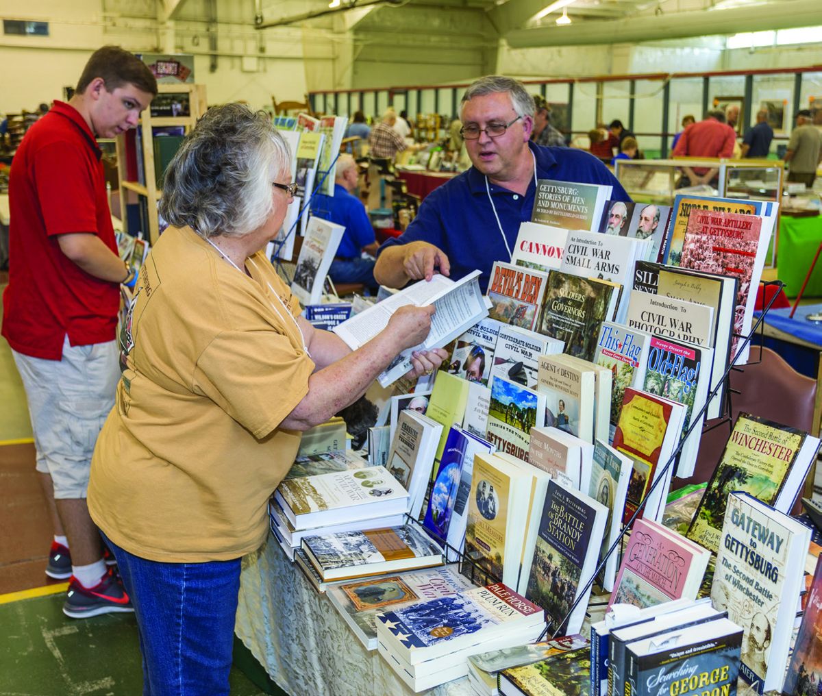 Jim Schmick of Civil War and More books in Mechanicsburg, Pennsylvania, assists customers at his table.