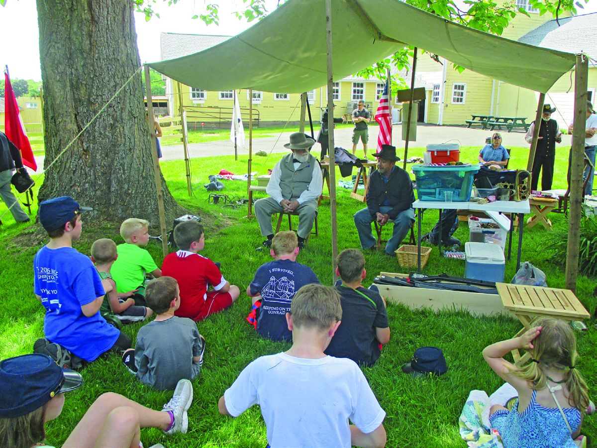 The photos show 14th CVI Co G members helping the campers in the tent set up activity and General Lee and General Grant bringing the day
