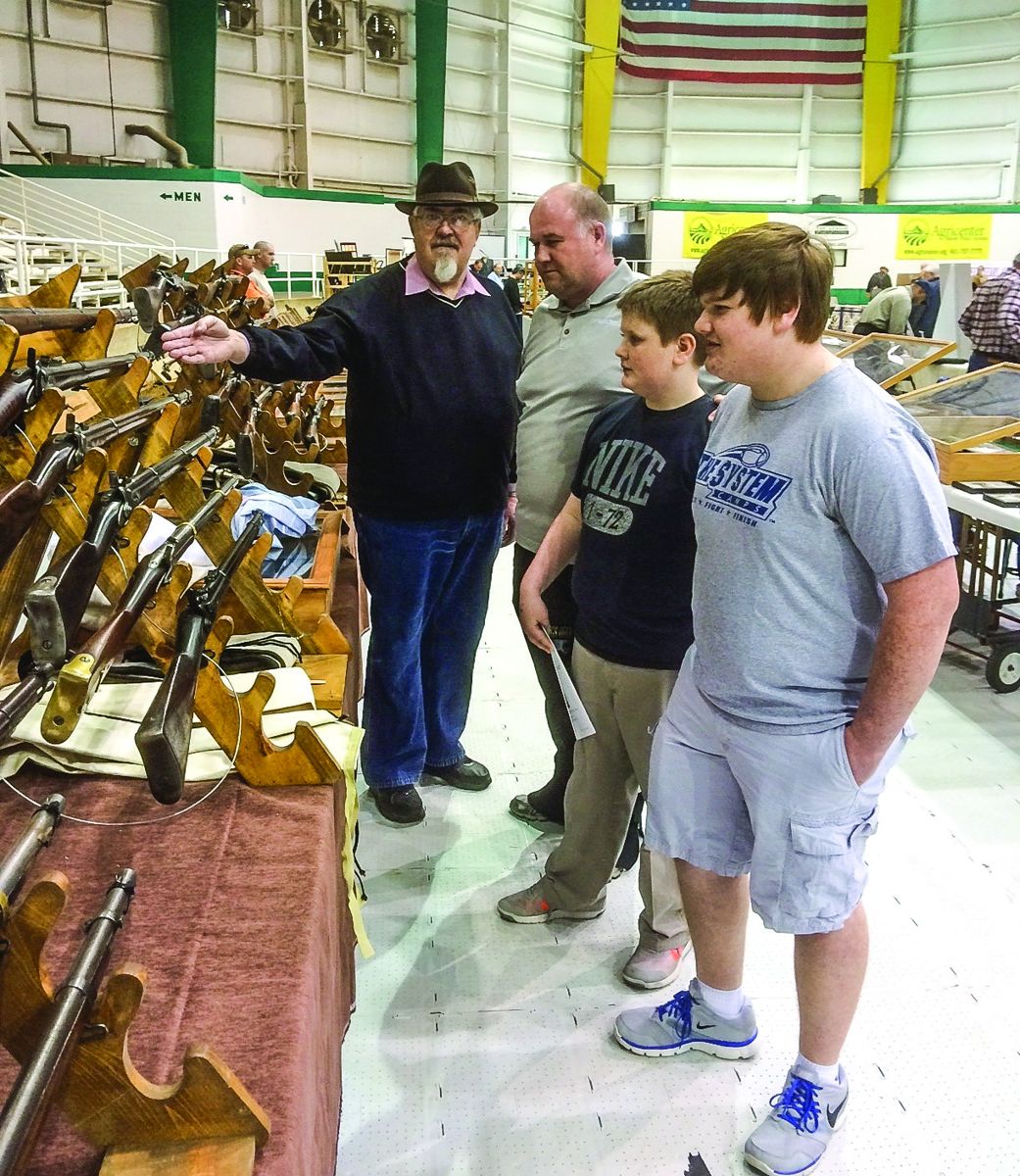 Several dealers and displayers had an opportunity to engage the attendees, young and older, to educate them on their displays or items for sale such as Ken Chrestman seen here talking with three attendees.