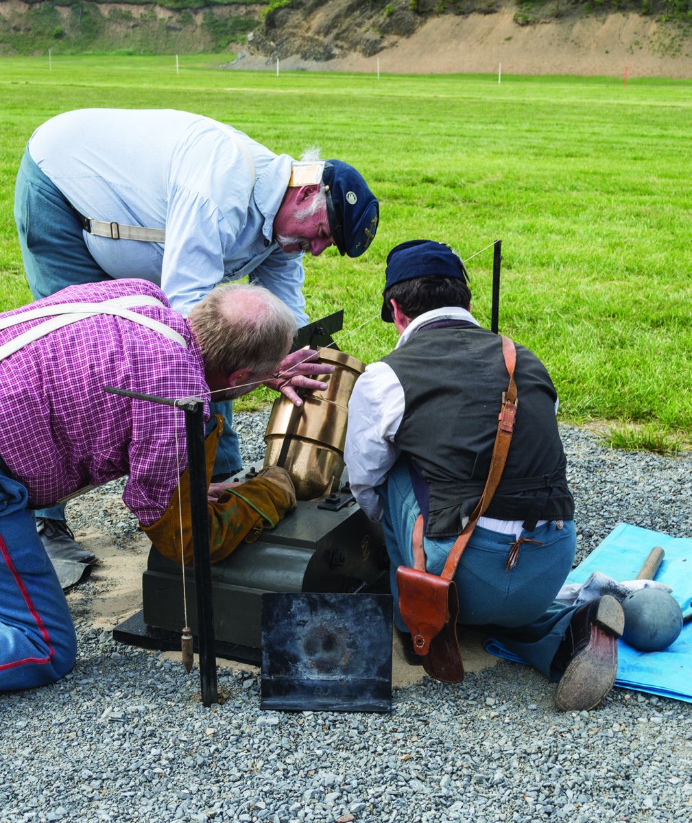 Mortars must be carefully set up to achieve superior accuracy. A plum bob adjusts the windage and the powder charge determines the distance. Here they are setting up a bronze 24-pounder Coehorn mortar.