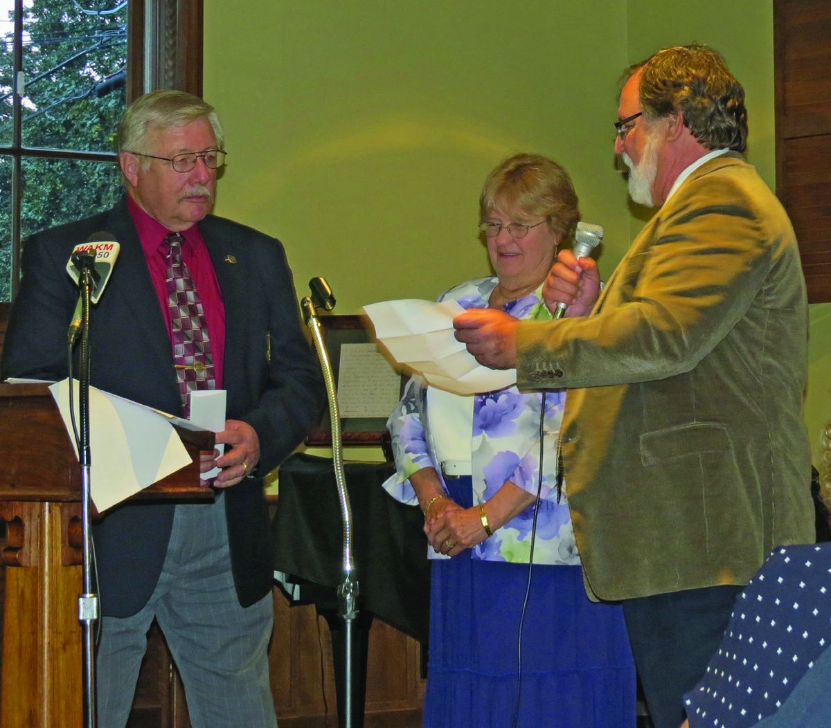 Han Hooker, left, Virginia Hooker-center receive letters of commendation from Franklin Alderman and Round Table member Michael Skinner.