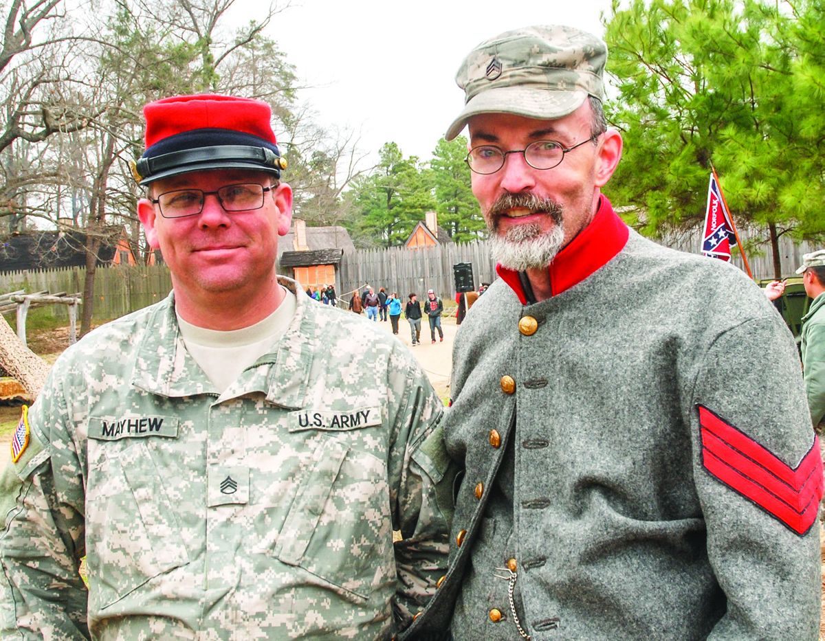 Staff Sgt. Scott Mayhew (retired) and Chris Hoggard swapped headgear and participated in firing the other unit’s weapon.