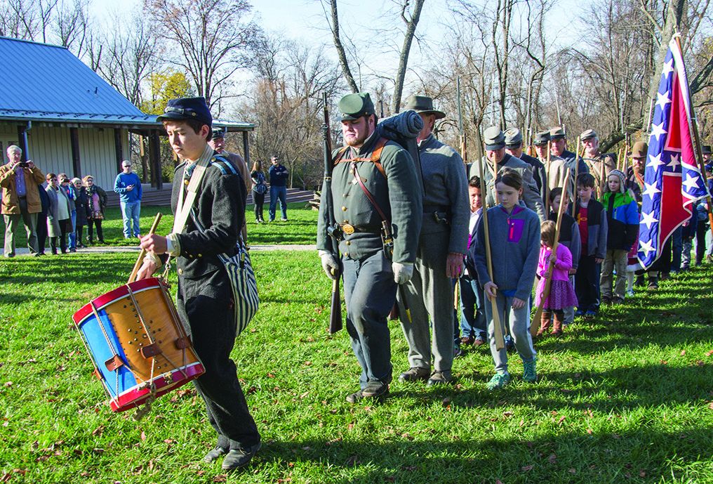 Drummer Ryan LeVault from Herndon, Va., with the 13th Virginia Infantry, Co. I, leads the troops through drill while families watch.