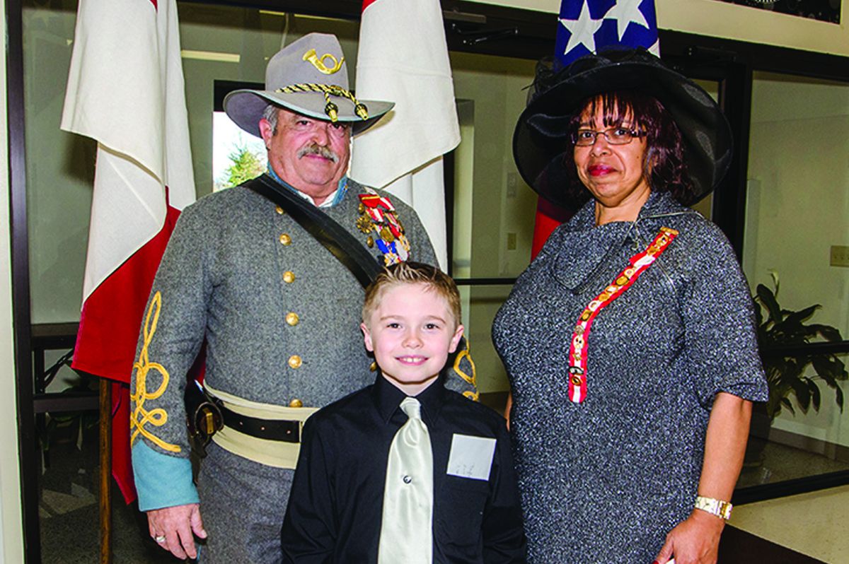 A UDC Culpeper Chapter 73 essay prizewinner, Dylan Emmel, 8, from Culpeper, Va., who is related to Robert E. Lee collaterally through his mother, is proud of his heritage and asked to be photographed with keynote speaker Teresa Roane and Commander Christopher H. Ezelle, Military Order of the Stars & Bars Chapter 258. (Nancy Jennis Olds)