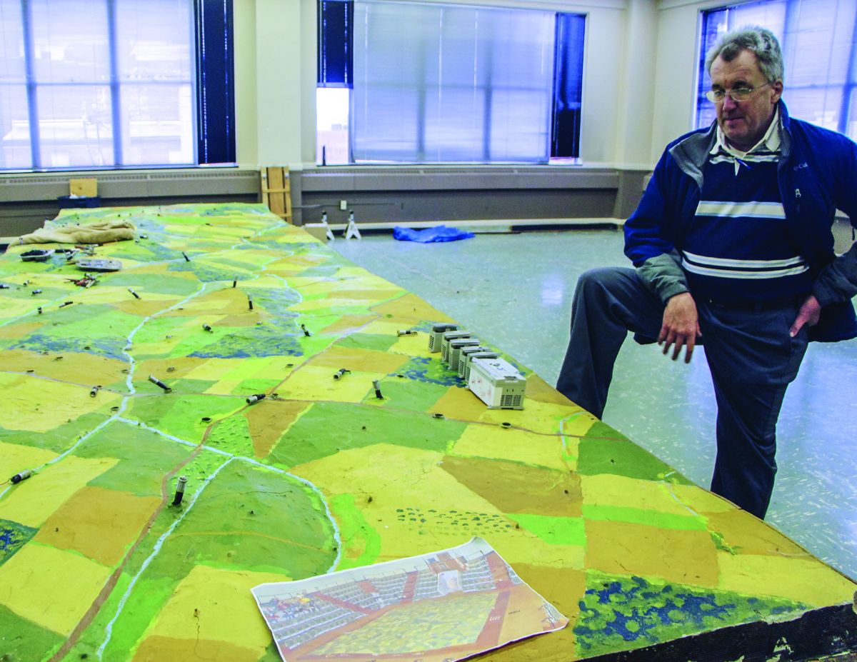 Owner Scott Roland stands next to his electric map project.