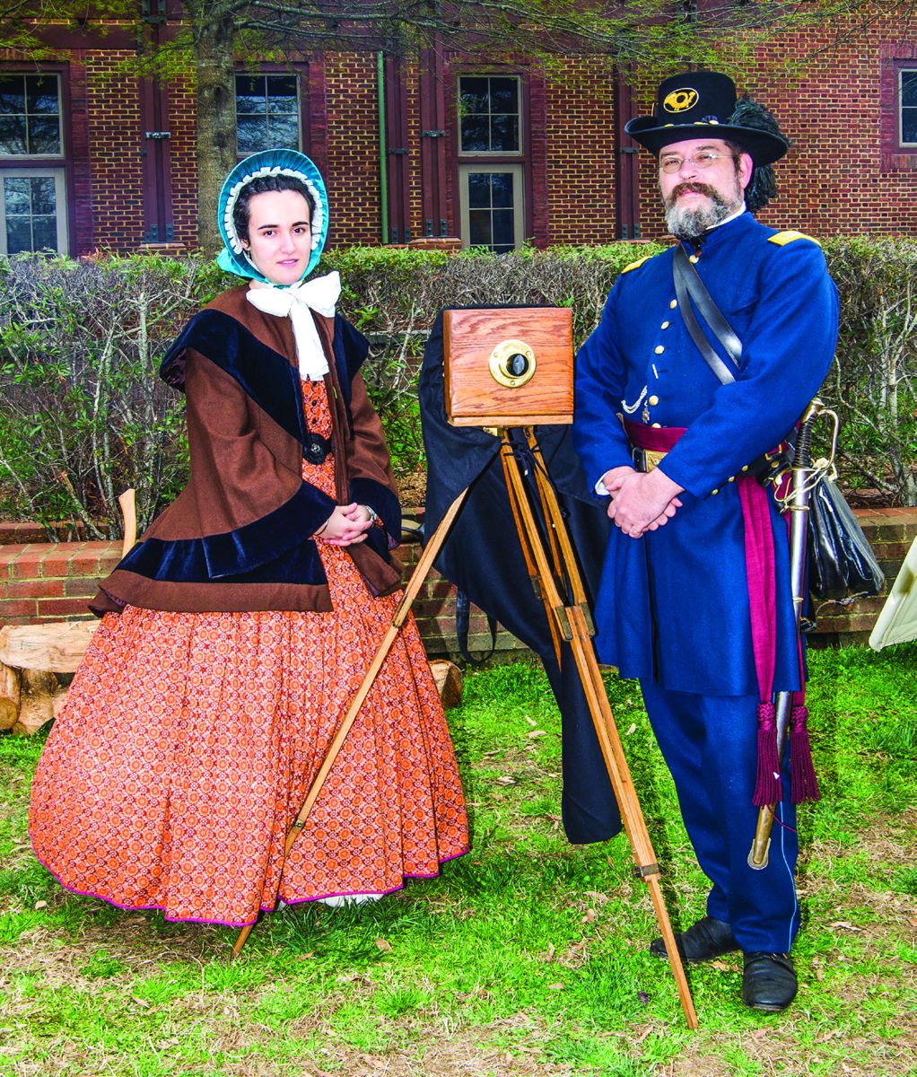 3rd U.S. Regulars members Mary Quinn Eakins and 1st Lt. Paul Stier posing by a replica antique camera.