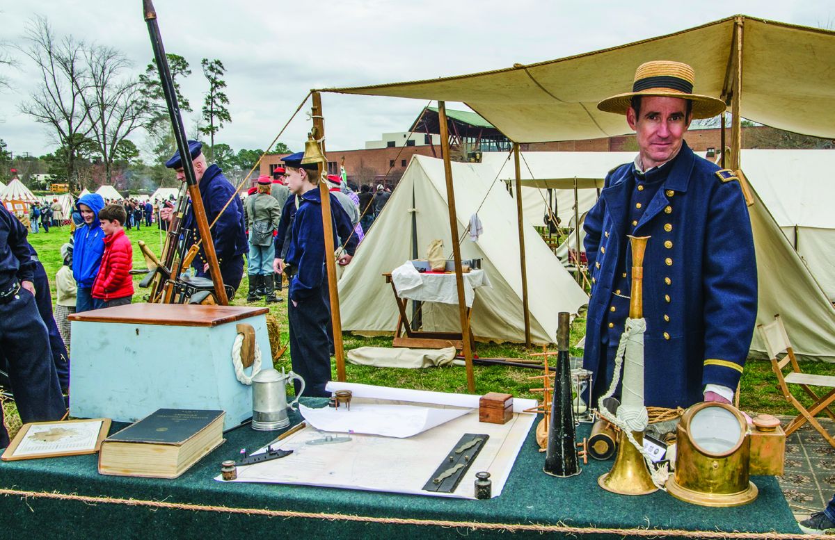 Lt. Kurt Eberly is the paymaster of the Tidewater Maritime Living History Associates unit. He is standing by the maps, official books and instruments needed for the voyage on the USS Aroostook, June 1862.