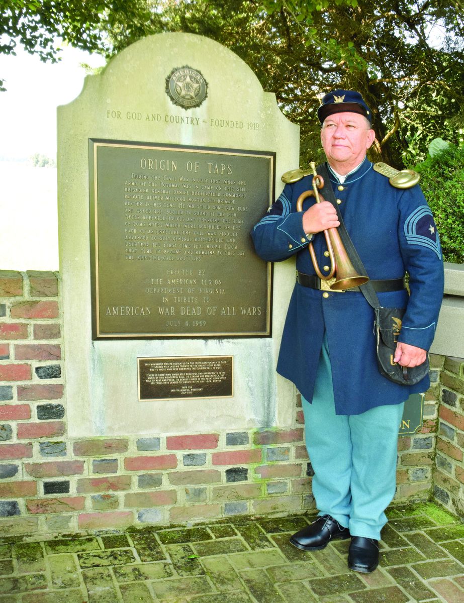 Master Sergeant Jari Villanueva stands in Civil War period garb with his bugle at the Taps Monument at Berkeley Plantation where the bugle call that we know as Taps was born during the summer of 1862.