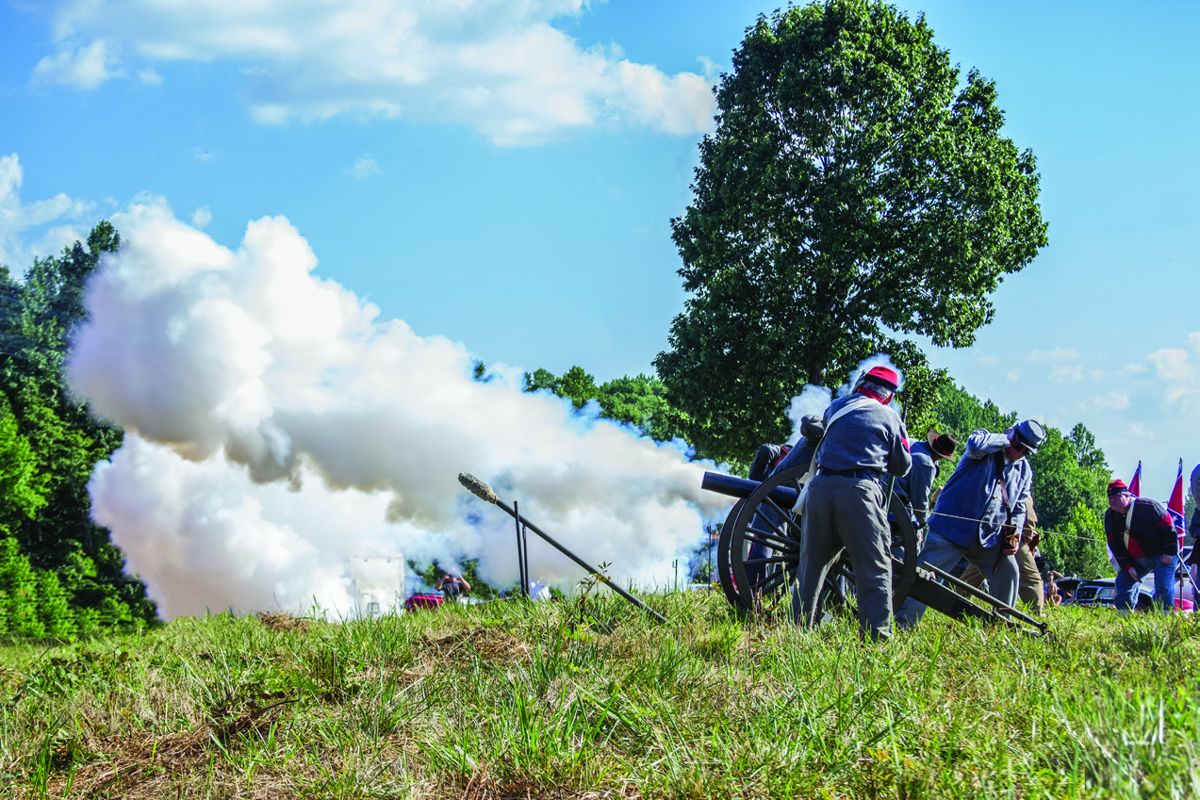 After the raising of the flag, members of the Orange Light Artillery, 40th NC Troops, CSA fire artillery volleys to mark the occasion.