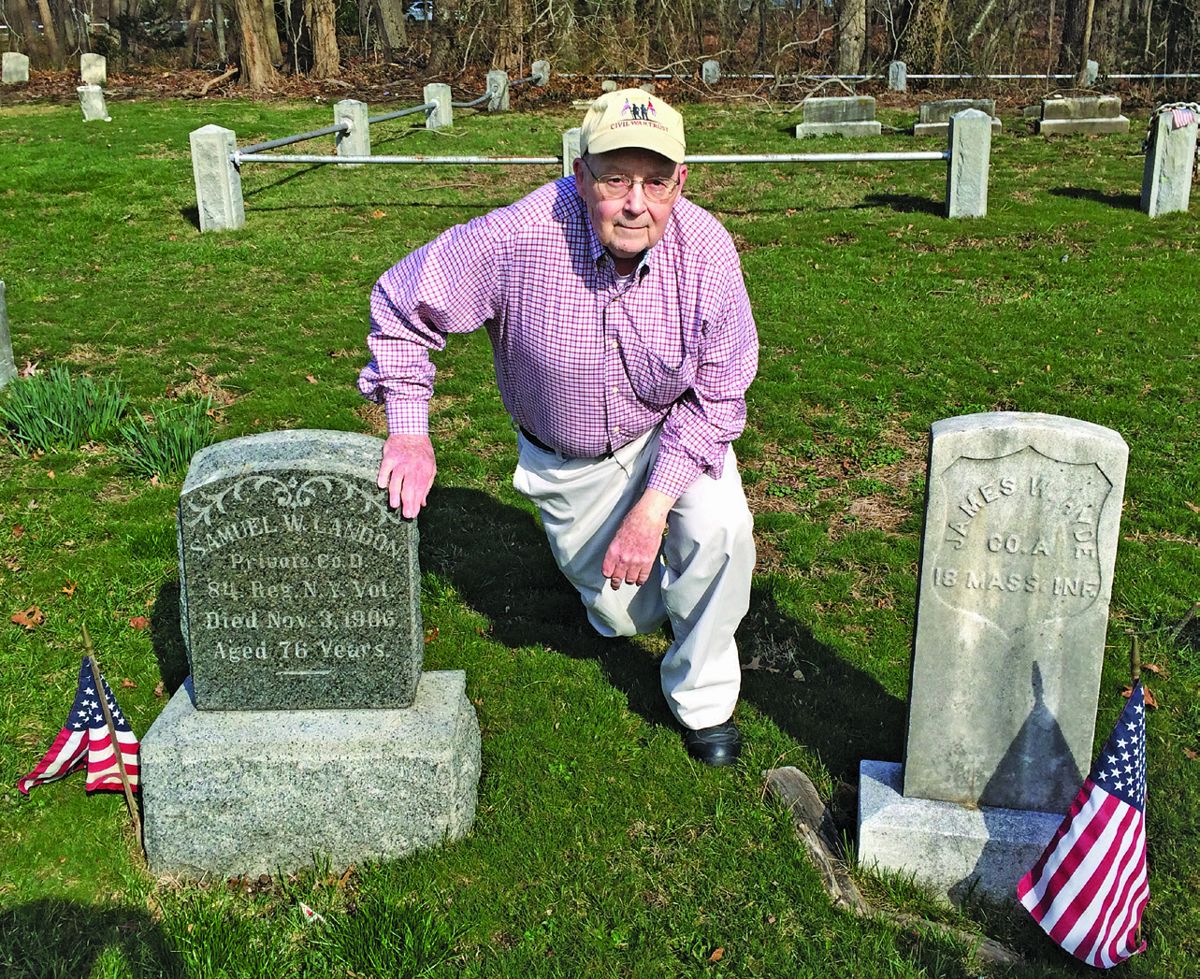 Historian and author Robert Farrell kneeling next to the graves of Samuel W. Landon, Pvt. Col. D, 84th Reg. N.Y. Vol. and James W. Hyde, Co. A, 18th Mass. Inf.