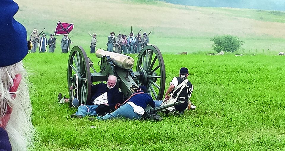 A steward accesses the conditions of a fallen gun crew of the 6th Independent Battery, New York Light Artillery cut down by the Confederate artillery barrage preceding Pickett’s assault on Cemetery Ridge.