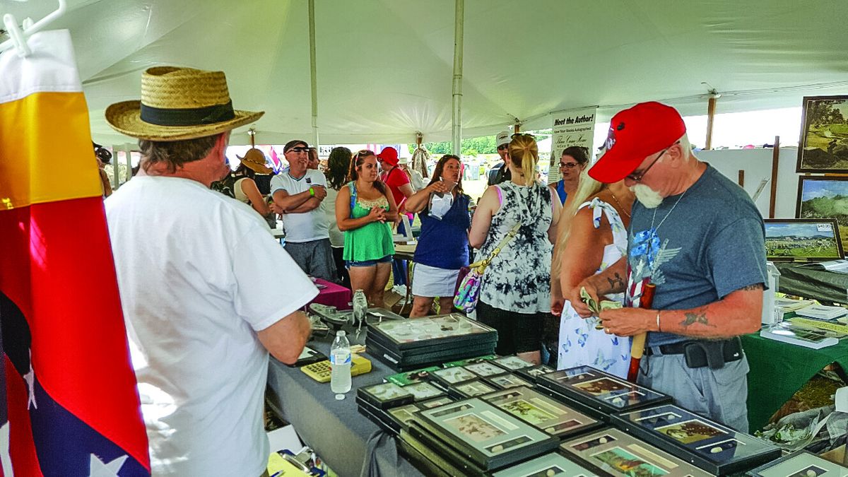 The Artist and Authors Tent at the Annual Gettysburg Civil War Reenactment is a popular place for informative displays as well as purchasing art, books and Memorabilia.