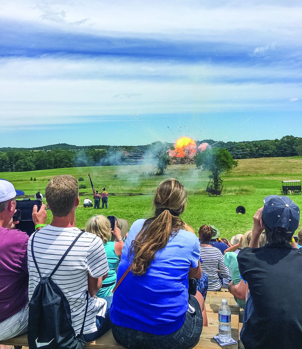 Spectators enjoy the “explosive ending” of the live mortar fire demonstration at the annual Gettysburg Reenactment.