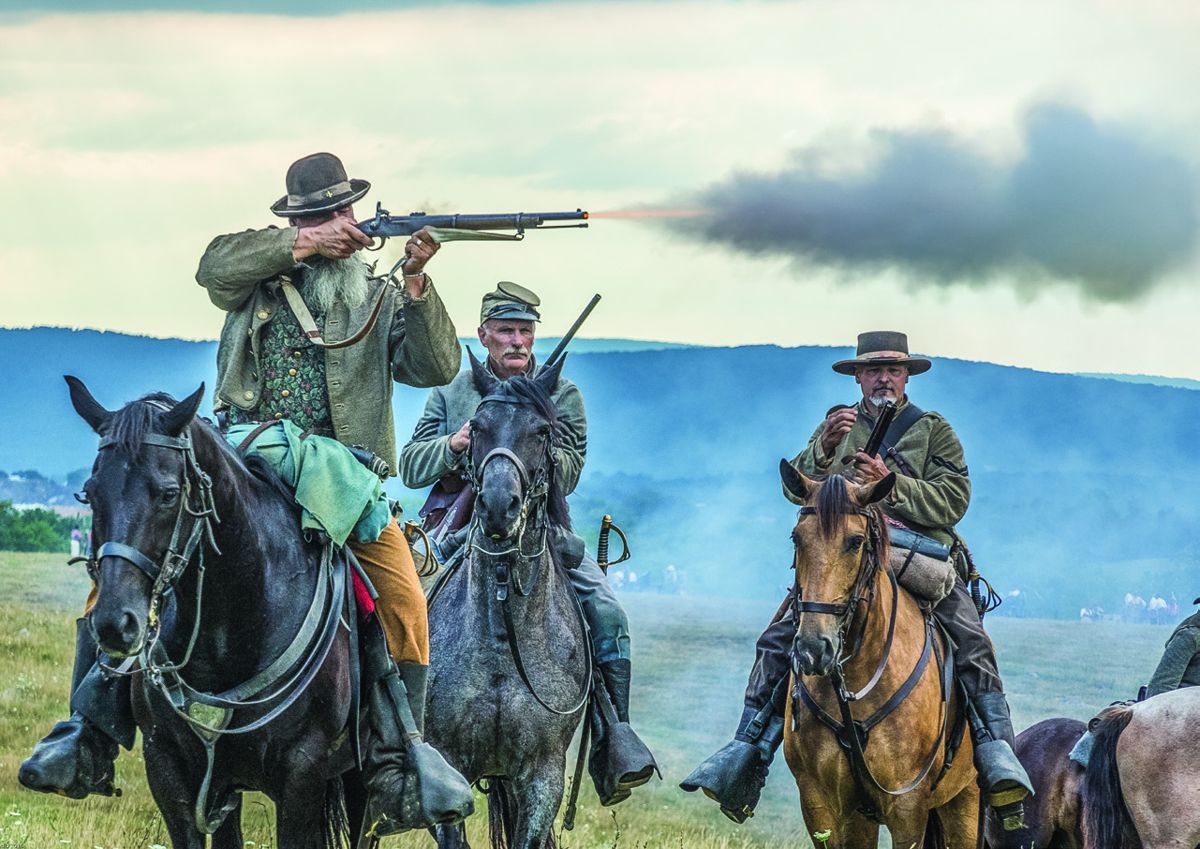 David Chirico, 4th Virginia Cavalry “Blackhorse” sends a round into the attacking 2nd U.S. Cavalrymen charging toward him during the dusk encounter of the reenactment of First Manassas. Note the shorter firearm used by cavalrymen. Carbines, shotguns and musketoons were carried by the cavalry along with revolvers or other hand guns.