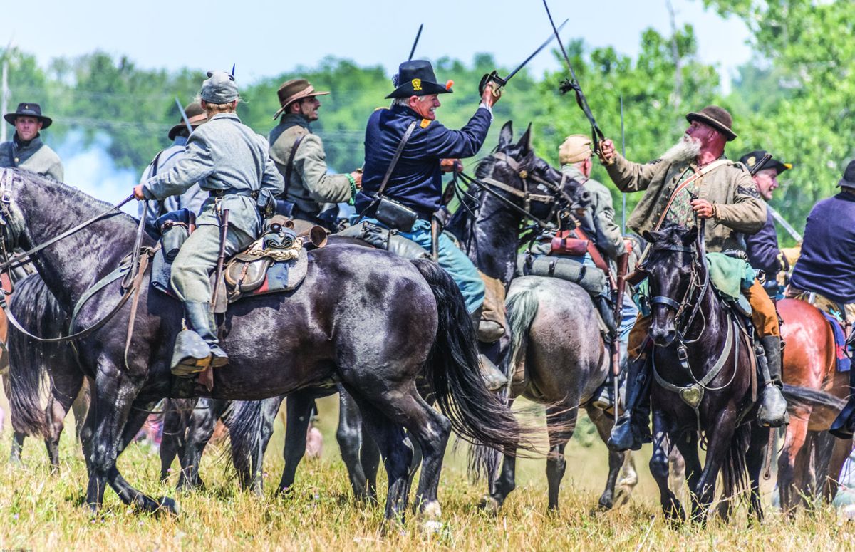Cavalry fights are furious, confusing events. Charlie Doutt, 2nd U.S., Co A crosses sabres with David Chirico, 4th Virginia Cavalry (“Blackhorse”) during the final cavalry battle of the reenactment.