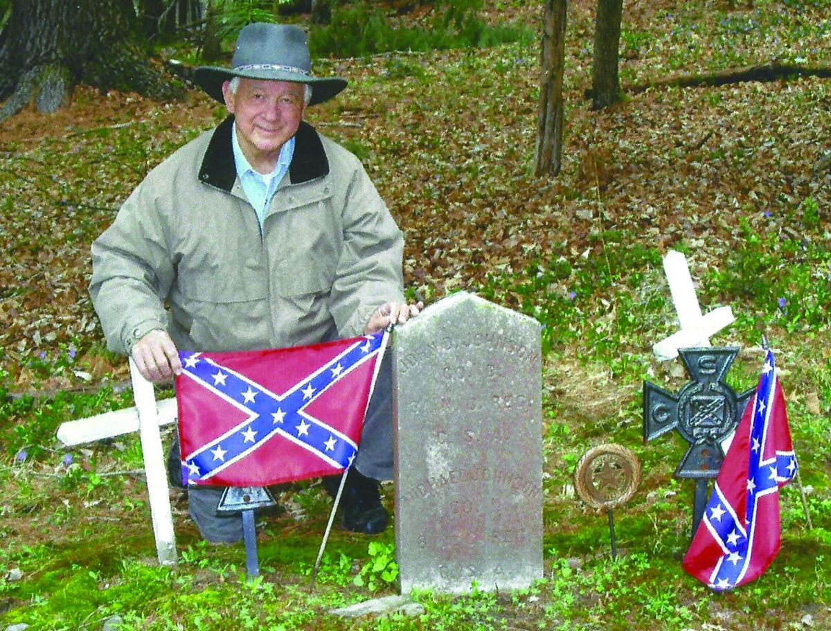 The author, John A. Panola, placing flags at the gravesite of Confederates who are buried in a small church yard in Barryville, N.Y.