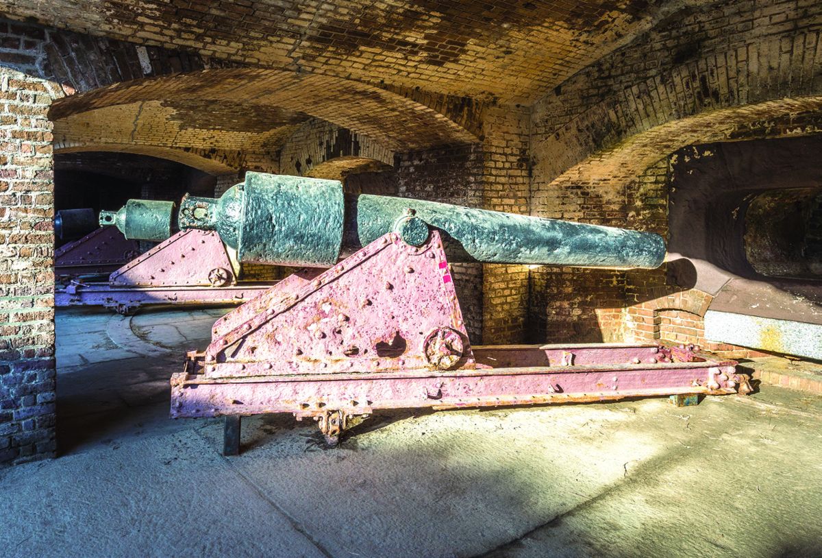 Photo of a U.S. 100-pounder, 6.4-inch caliber Parrott rifle on its original iron carriage located in Fort Sumter before conservation.