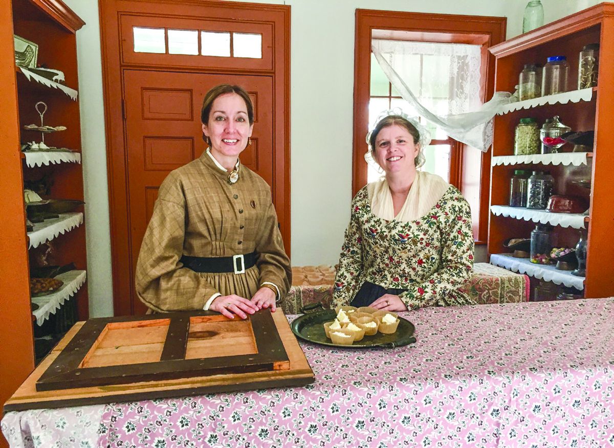 Christina Herold, of Haymarket, Va., and Sherri Groff, of Atco, N.J., greet visitors to the Confectionery Shop with pieces of cake in honor of Washington’s Birthday.
