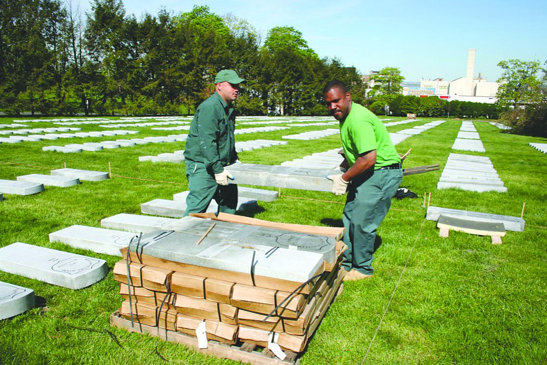 Green-Wood workers laying out Veterans Affairs gravestones in 2007. Almost half of the Civil War veterans were in unmarked graves.