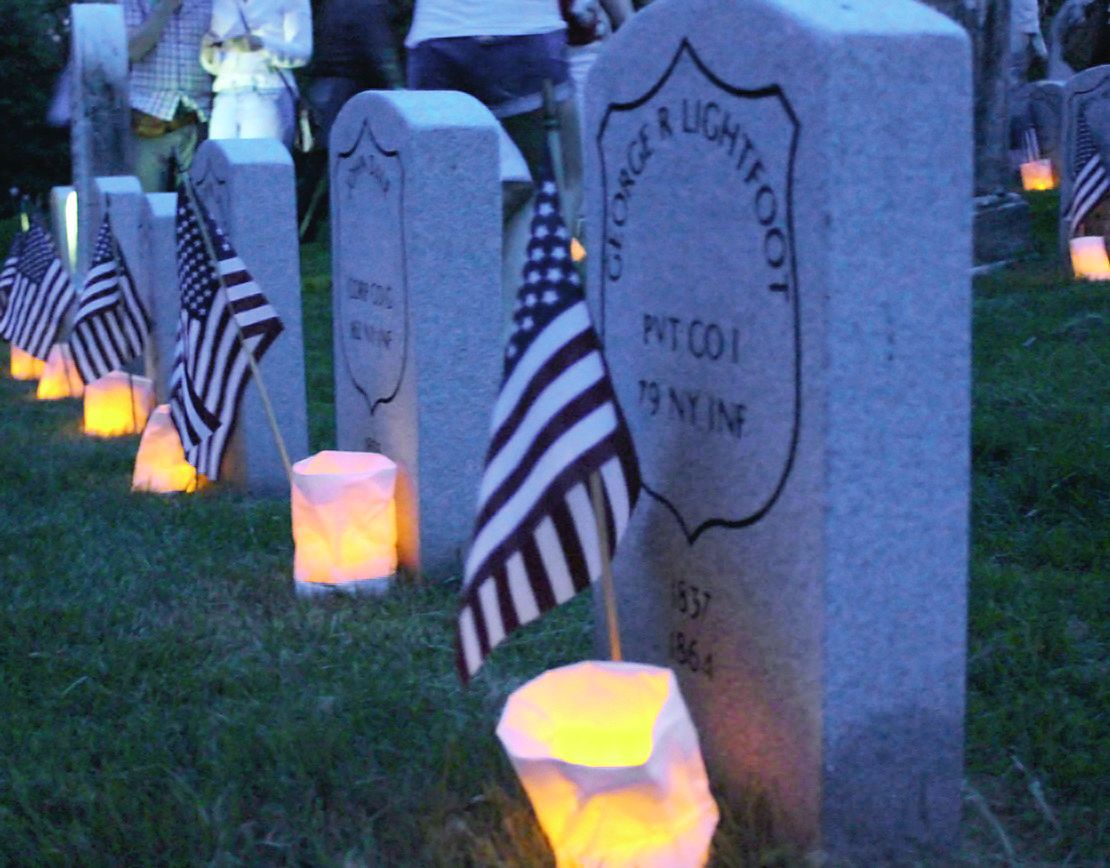 Luminaries in Green-Wood Cemetery’s Civil War Soldiers Lot, lighting the gravestones of veterans.