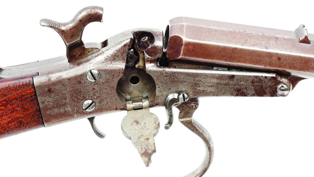 Close-up of #2323 showing the primer door open and the internal mechanism for advancing the primers. The ram’s horn shaped pin in front of the primer door is the only part that must be removed to unlock the barrel and disengage it from the frame.