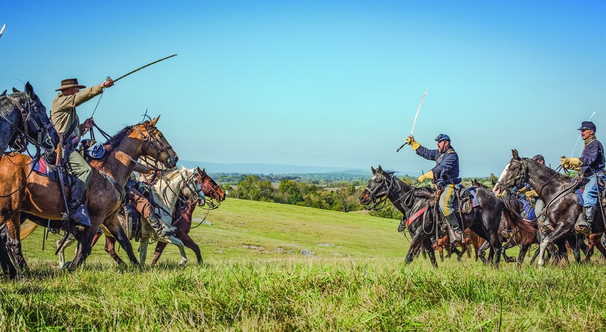 Confederate and Union cavalry engage in a fight.