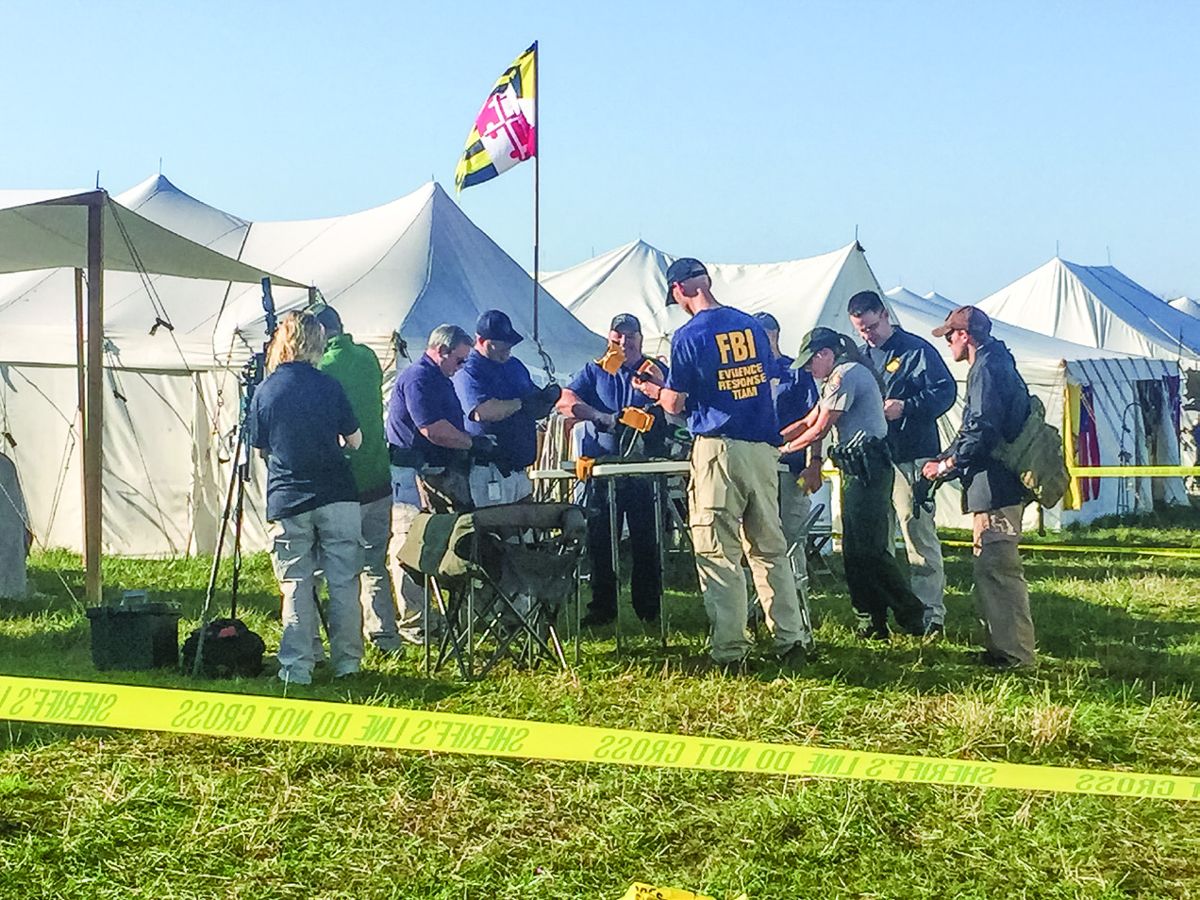 Law enforcement and FBI agents secure the device near the location where it was discovered. (John Buchheister, of the Maryland Sutler)