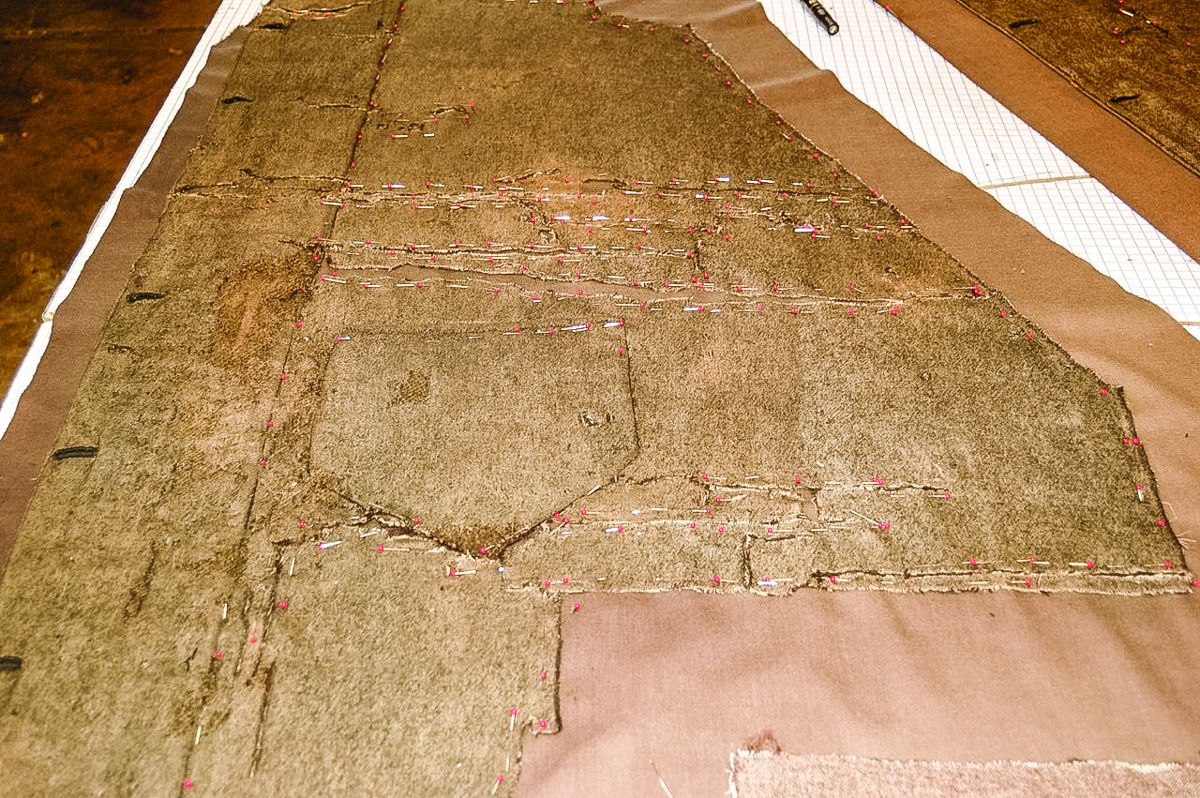 Coat panel, pinned to support underlayer, during treatment.