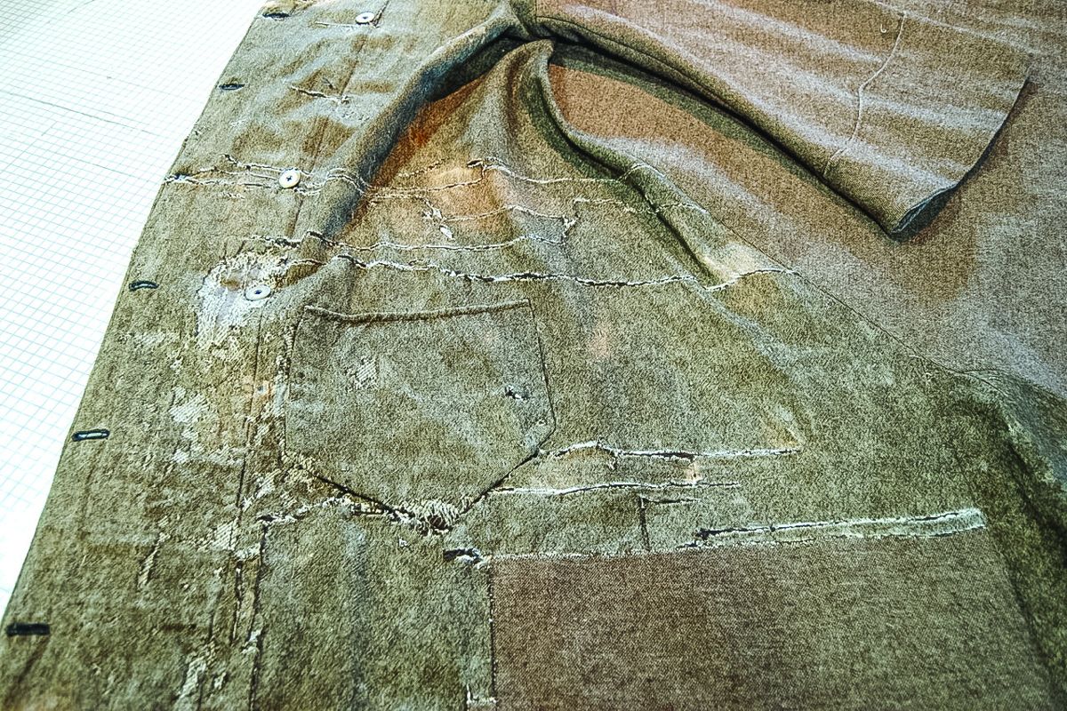 Detail, damage to left breast panel, before treatment.