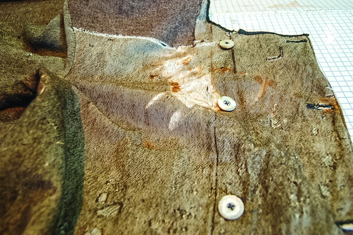 Detail, damage to upper right breast panel, before treatment.