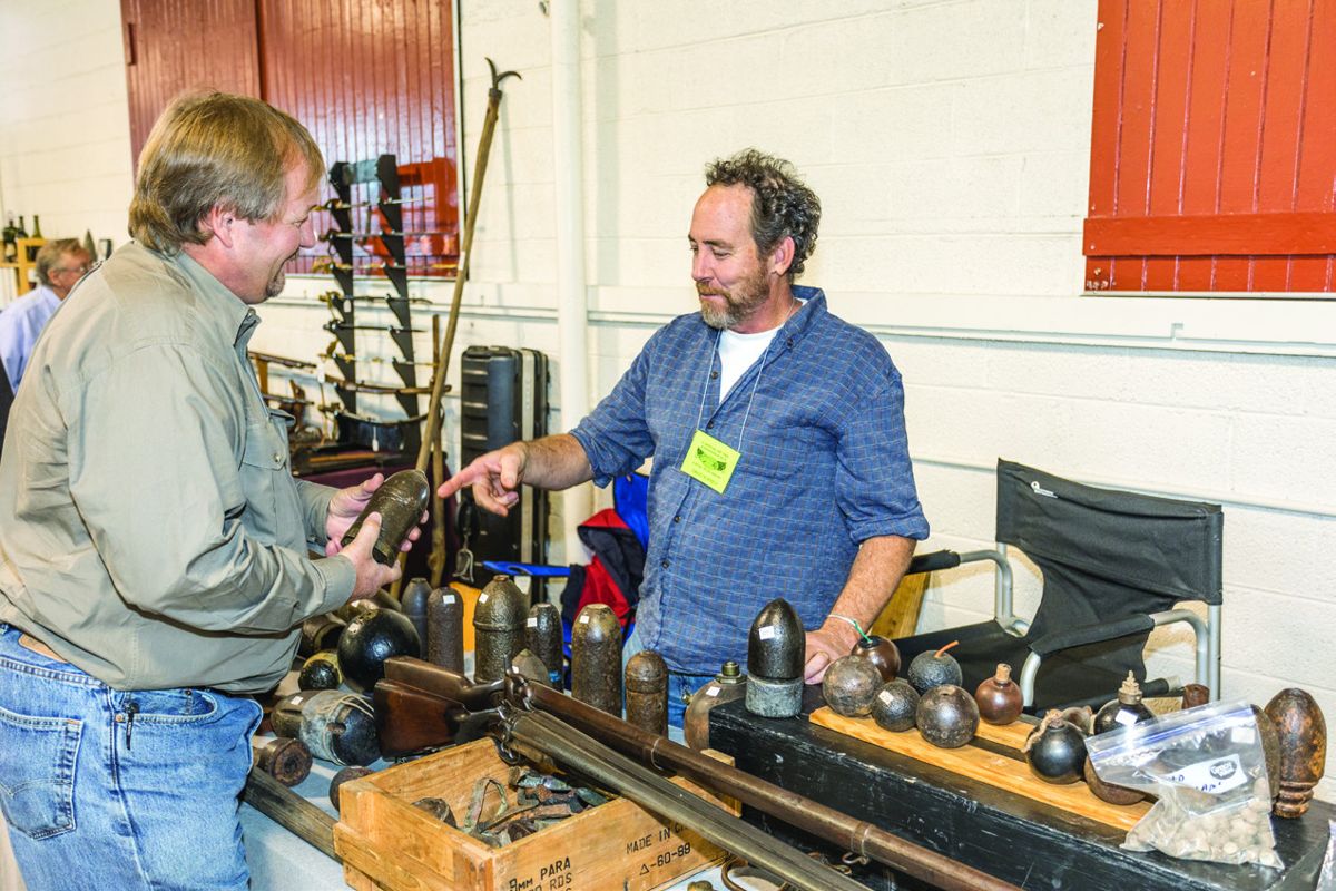 Glenn Dutton talks artillery shop with collector/dealer David Kornely.