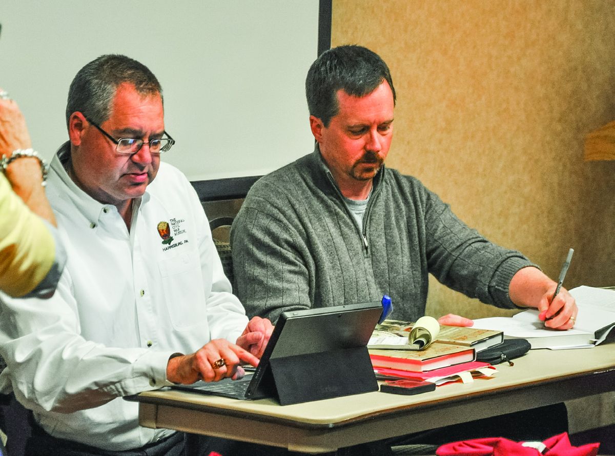 Wayne Mott and James Hessler sign copies of their book.
