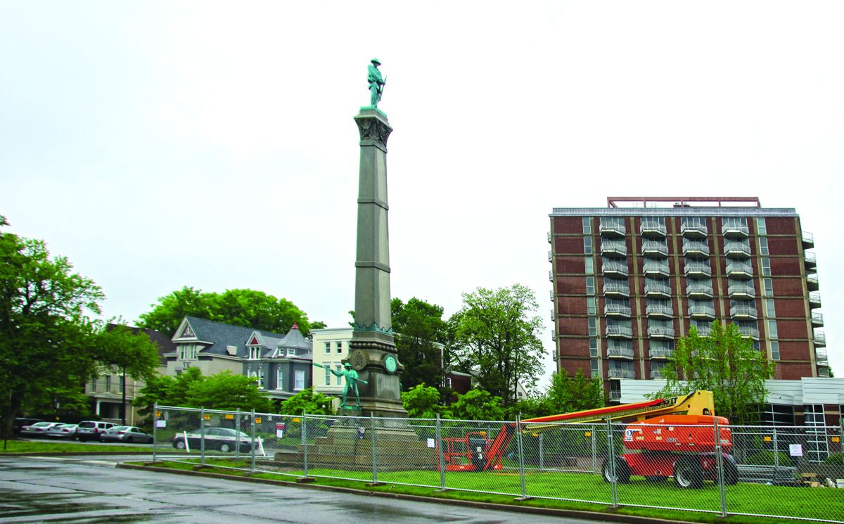 Confederate Monument with fence and construction equipment during the removal process.