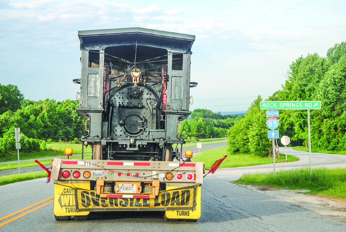 The Texas attracted many a stare as the Anderson Trucking Company hauled the oversized load down I-85 to Atlanta. The tender was carried on a second truck.