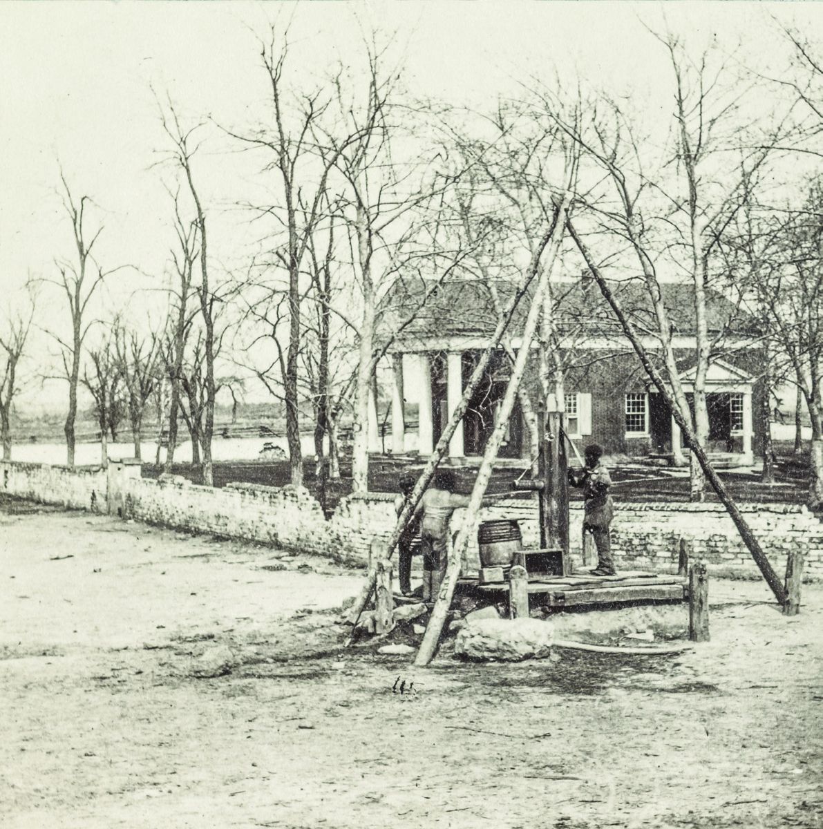 Spottsylvania [i.e. Spotsylvania] Court House. Photograph shows three men at the water pump in front of the Spotsylvania County Court House. (Library of Congress)