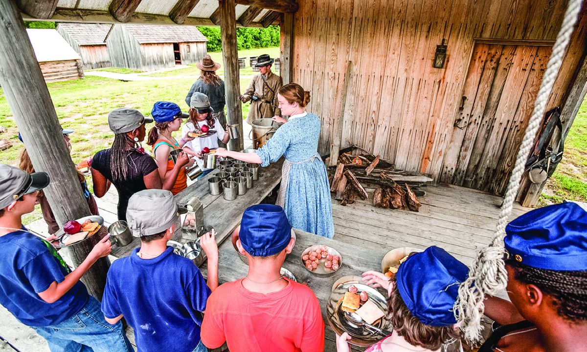Participants in Pamplin Historical Park’s Civil War Adventure camp line up for a meal.