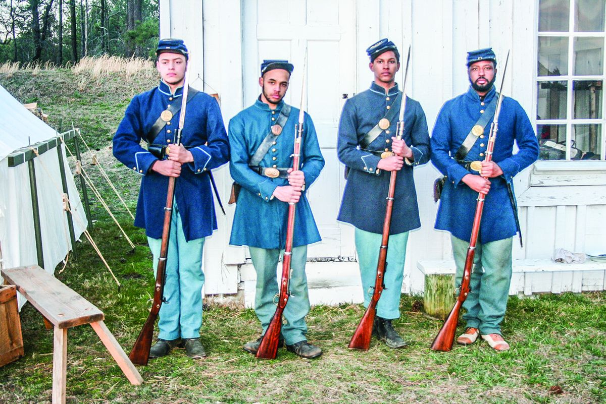 Jordan Bonardi, Noah Shiffer, Hugh Goffinet, and Marvin- Alonzo Greer prepare to go on guard duty. (John Peterson)
