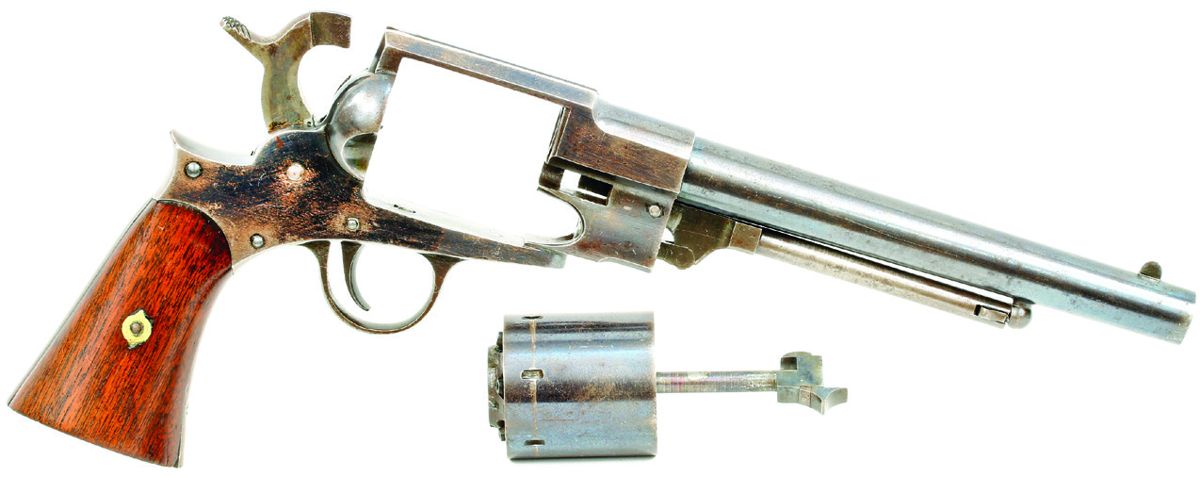 The Freeman Army Revolver with the cylinder removed from the frame, showing the cut in the frame to accept the pin and the arbor pin pulled forward to allow its removal.