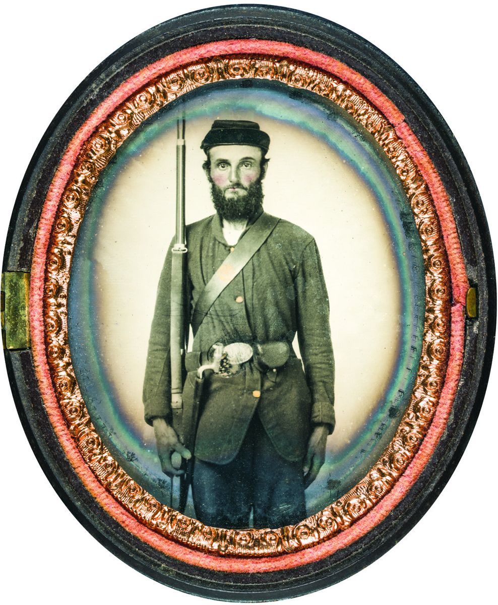Union soldier holding a U.S. Model 1861 Springfield rifle along with his accoutrement belt, socket bayonet, and percussion cap box. The strap across his body is attached to his cartridge box. (Library of Congress)