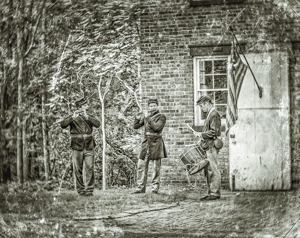 (L-R) Craig Anderton, Don Meninitz, and Brian Steffey raise the soldiers’ spirits with a song.
