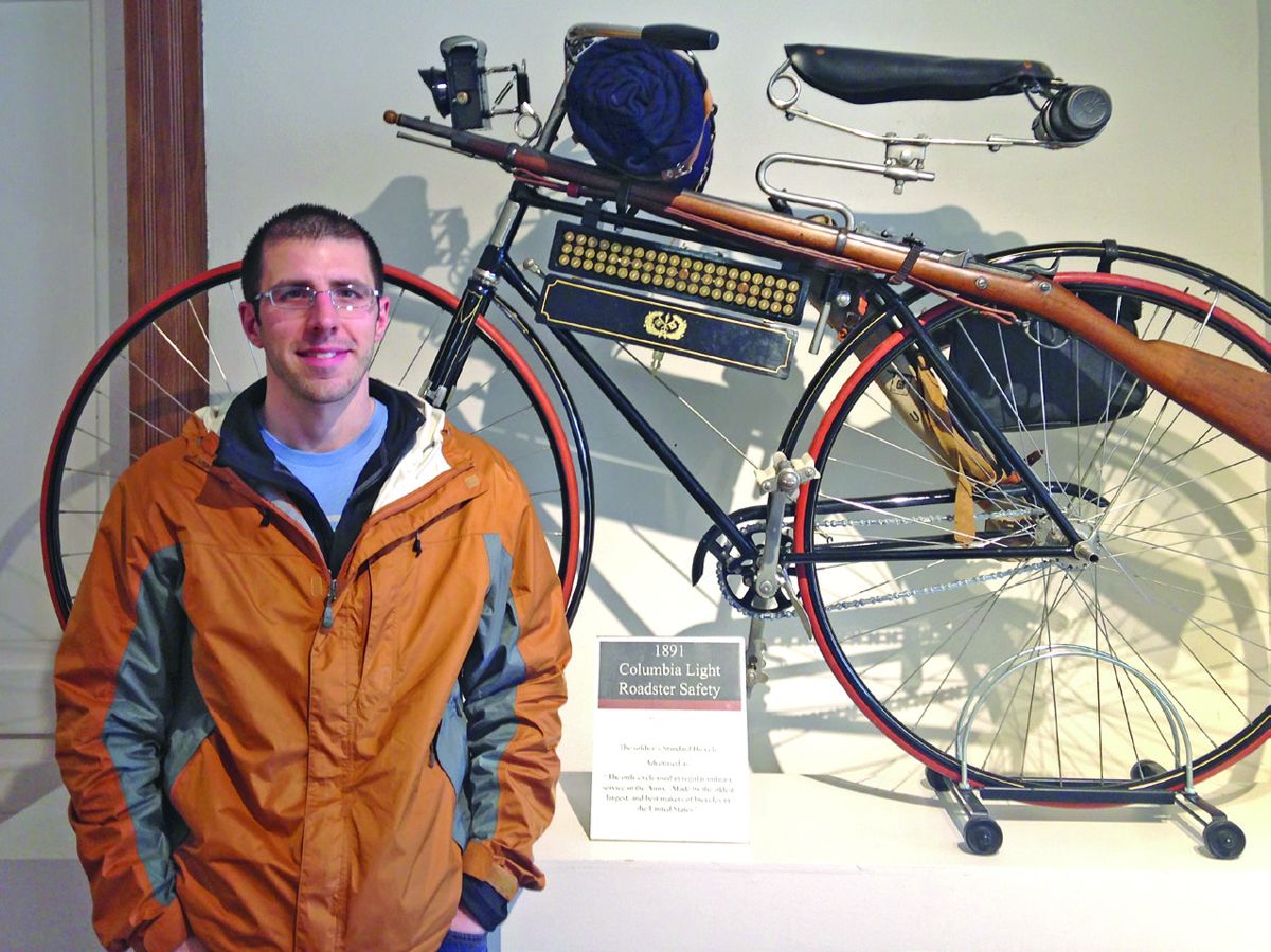 Frank Jastrzembski standing in front of a 1891 Columbia Light Roadster Safety bike.