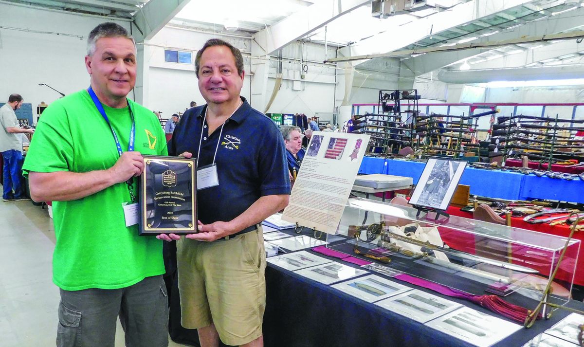 Jay Reid of Quakertown, Penn., received the GBPA’s Best of Show plaque from Charles Petrillo for his display centered on the sword presented to Capt. Charles McAnally, a recipient of the Congressional Medal of Honor for his actions during the Civil War.