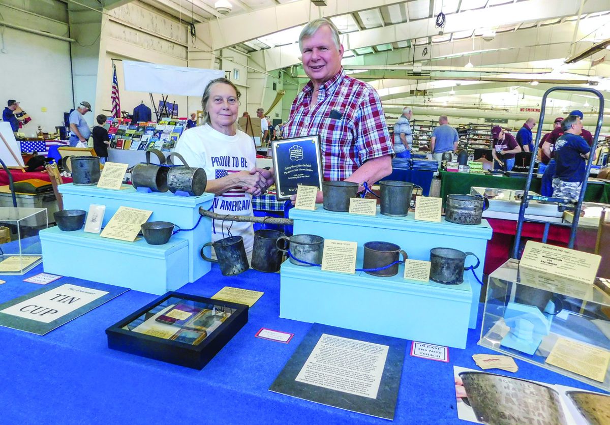 GBPA President Barb Mowery presented the Best Union Exhibit award to Paul Loane of Mt. Holly, N.J., for his display of Tin cups used by soldiers during the Civil War and at reunions afterward.