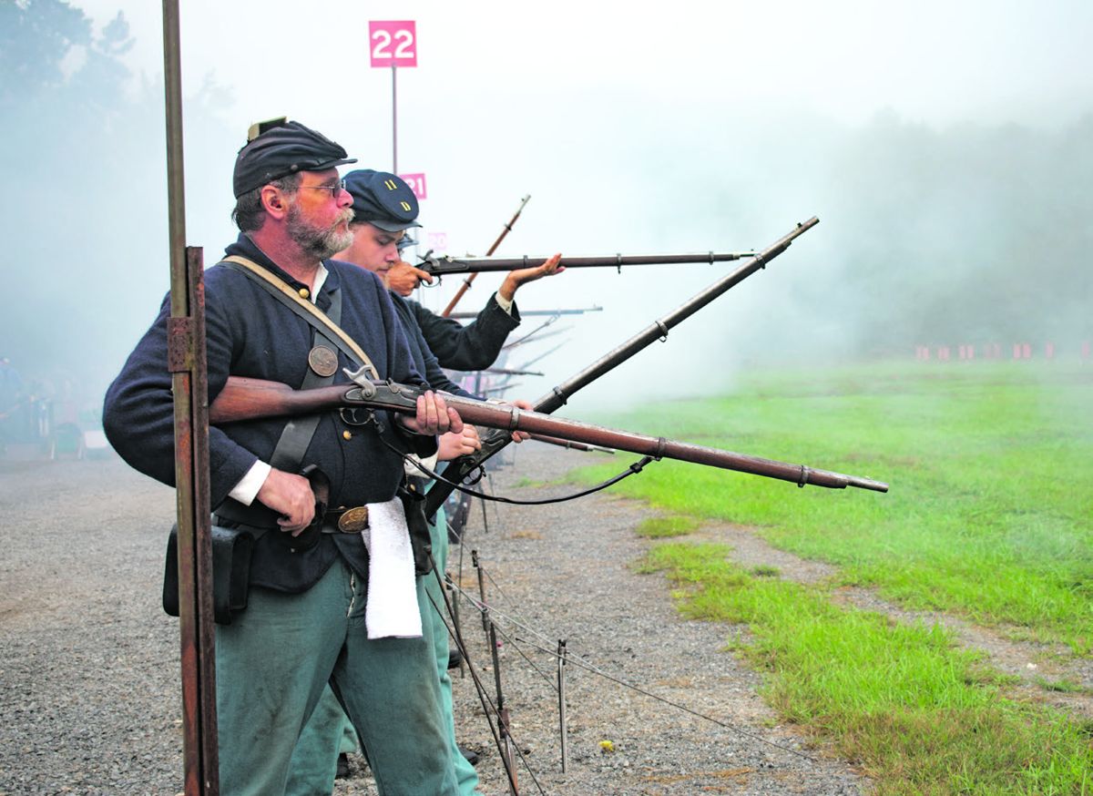 Through the thick smoke from the opening volleys of the N-SSA’s signature musket match, skirmishers fire at clay pigeons on a cardboard backer in the initial event of the competition.