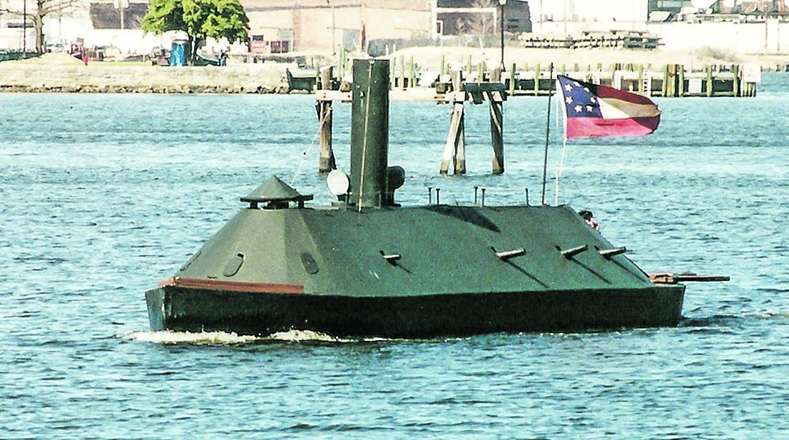 A scaled-down re-creation of the CSS Virginia sails on the Elizabeth River near the Portsmouth Naval Hospital during a commemorative ceremony.