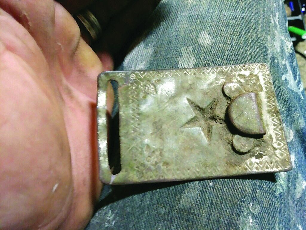 Reverse of plate show unique stamped design and riveted belt hook.