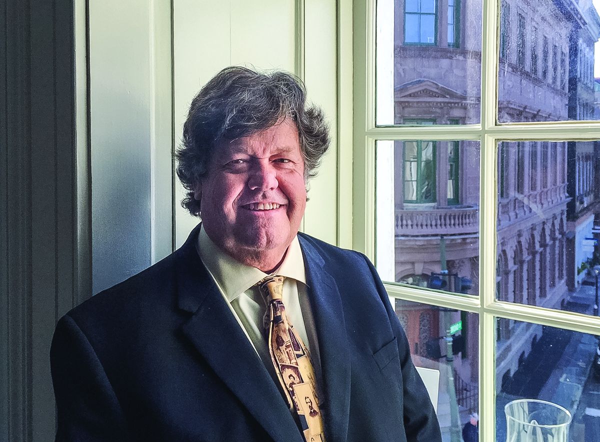 Bob Zeller smiles for a window lit photo overlooking Broad St. downtown Charleston.