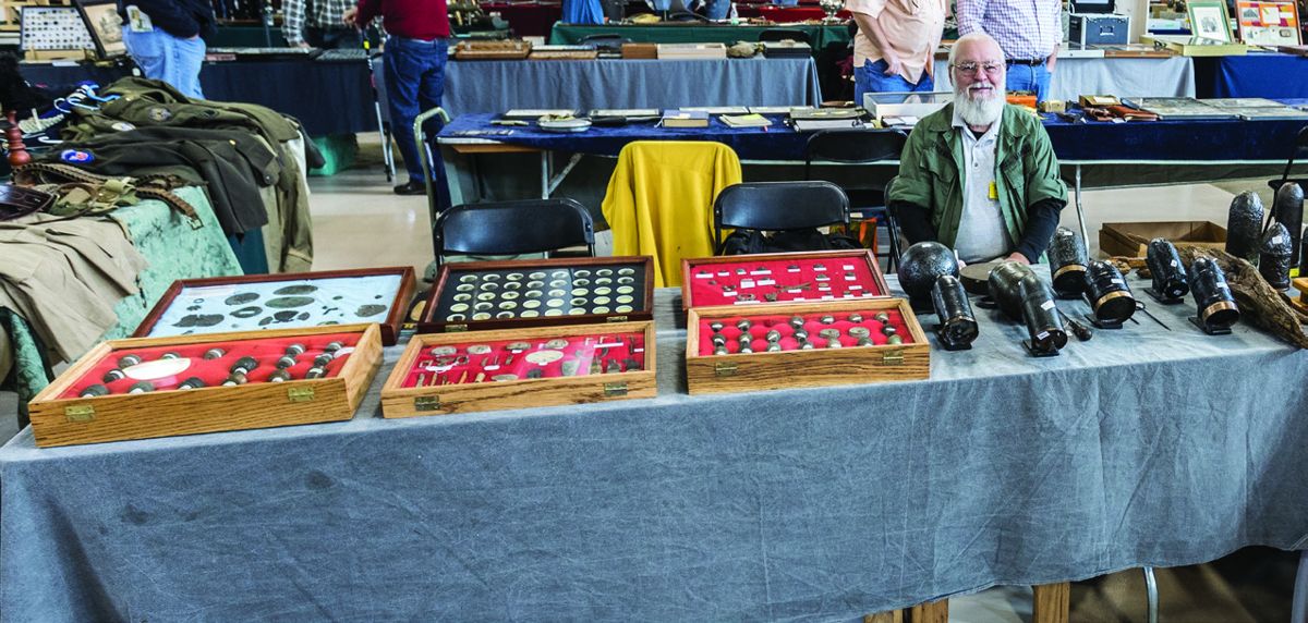 A smiling John Overmann manning Howard Alligood’s booth. (All photos Jack Melton)